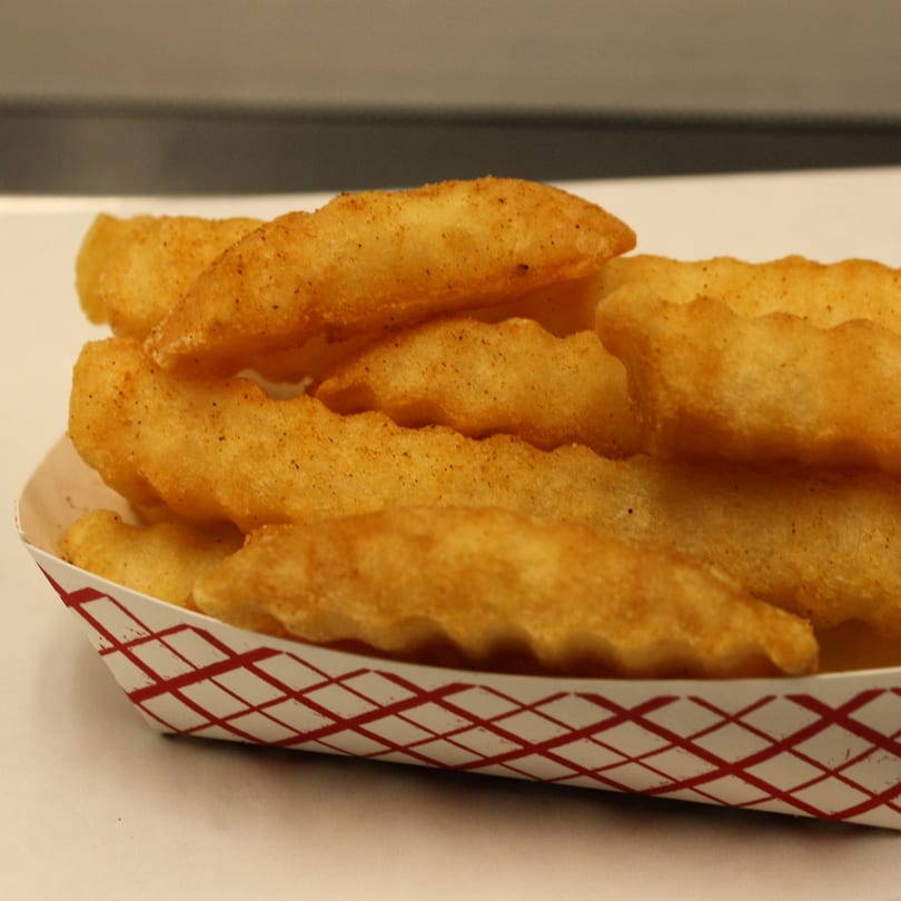 Joe's To Go Drive Thru's seasoned crinkle-cut fries in a red and white paper tray.